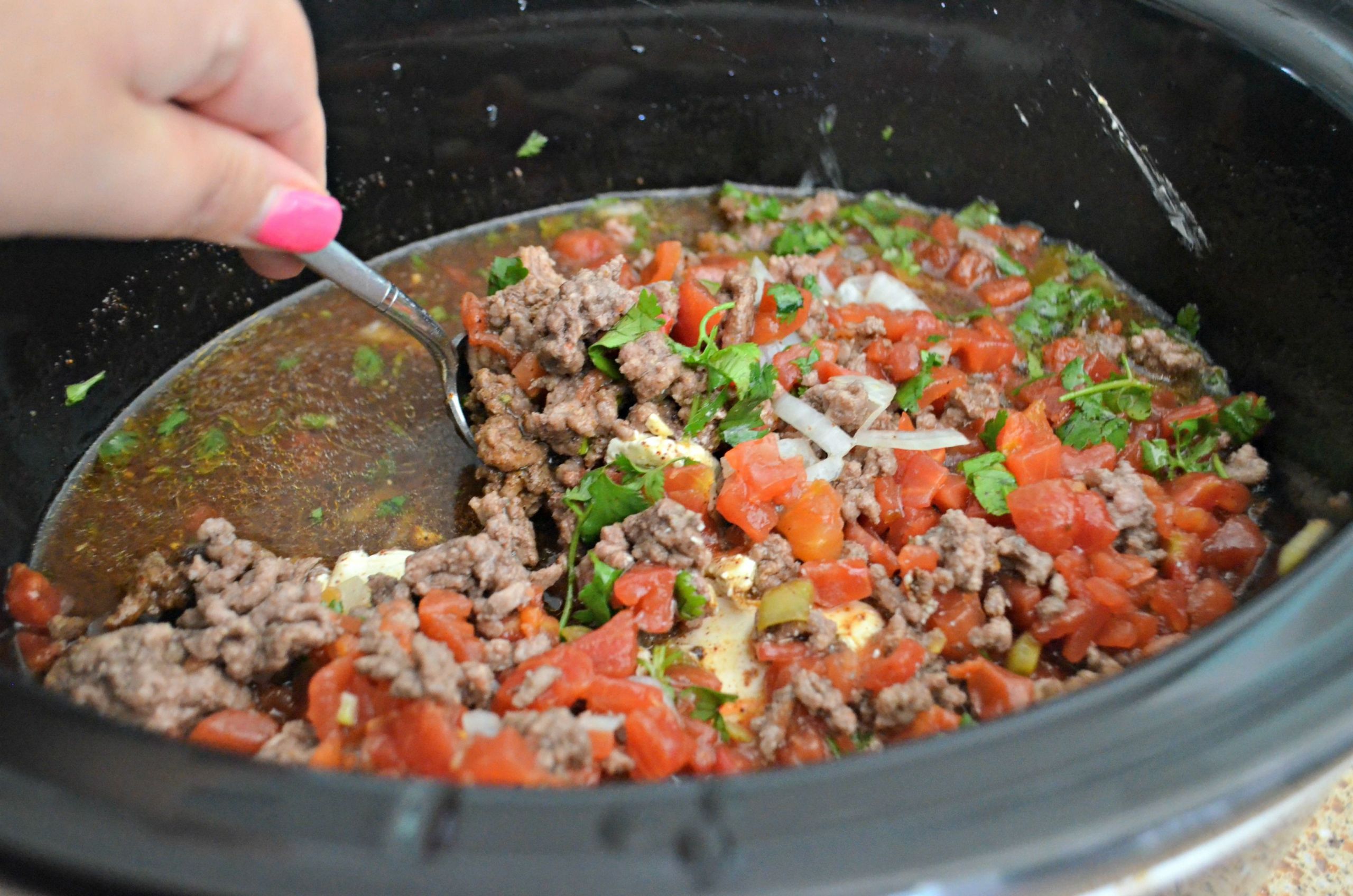 Slow Cooker Keto Taco Soup
 Stirring this easy slow cooker keto taco soup with a spoon