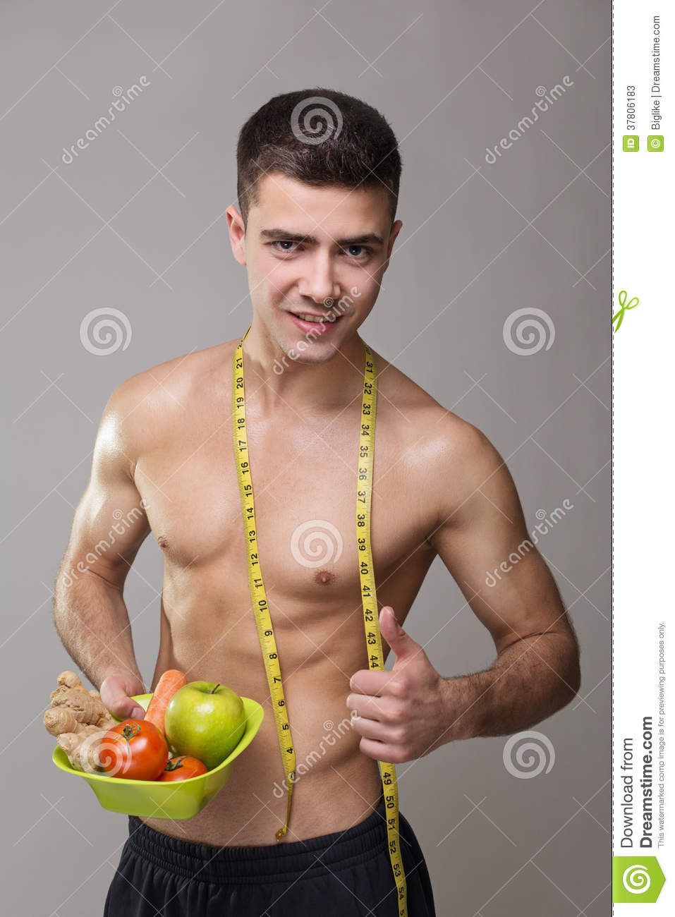 Healthy Food Vegan Fitness
 Fit Vegan Man With Measuring Tape And Healthy Food Stock